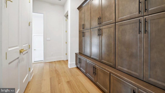 mudroom with light hardwood / wood-style flooring