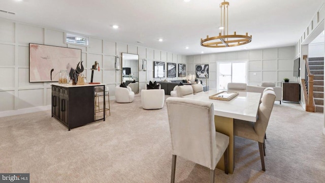 dining room featuring light carpet