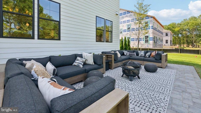 view of patio featuring an outdoor living space with a fire pit