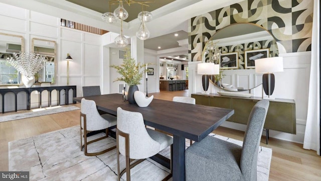 dining area featuring crown molding and light hardwood / wood-style flooring