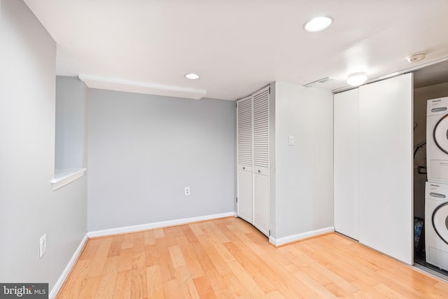 interior space featuring stacked washer and dryer and wood-type flooring