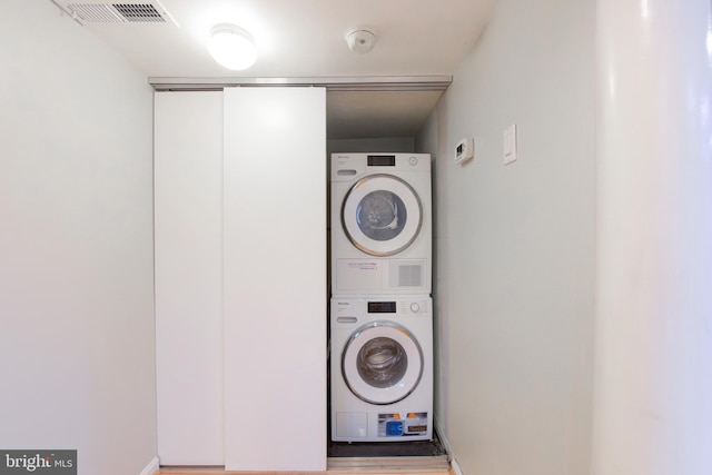 washroom featuring stacked washer / dryer