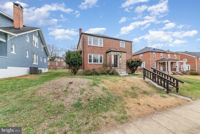 view of front of home featuring central AC unit and a front lawn