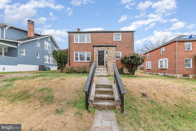 view of front facade with a front lawn and central AC unit