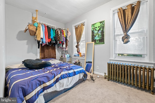 carpeted bedroom featuring radiator