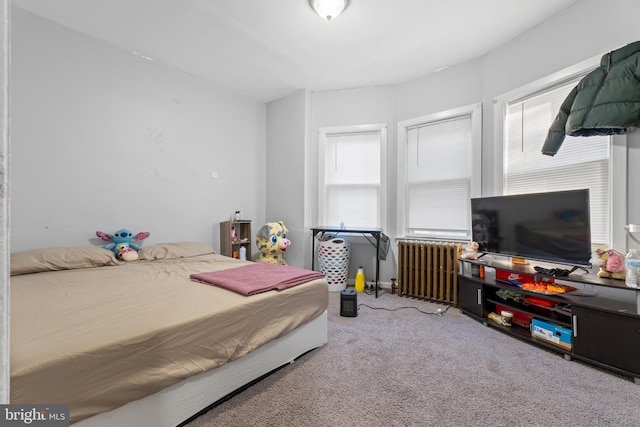 bedroom with carpet flooring and radiator heating unit