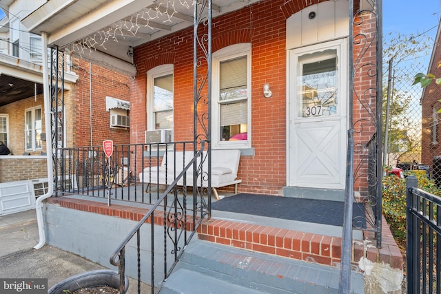 view of exterior entry with a porch