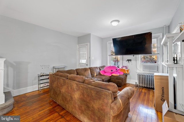 living room with dark wood-type flooring and radiator