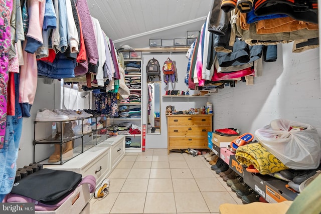 spacious closet with light tile patterned floors and vaulted ceiling