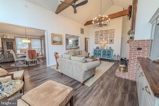 living room featuring dark hardwood / wood-style flooring, high vaulted ceiling, and ceiling fan with notable chandelier