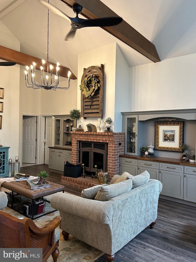 living room featuring beam ceiling, dark hardwood / wood-style flooring, high vaulted ceiling, and a brick fireplace