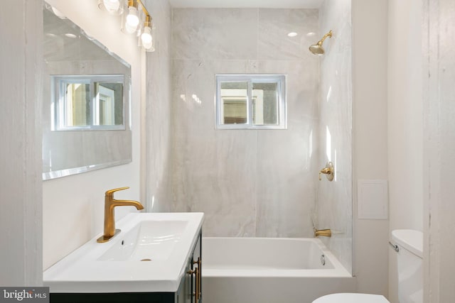 full bathroom with vanity, toilet, and tiled shower / bath