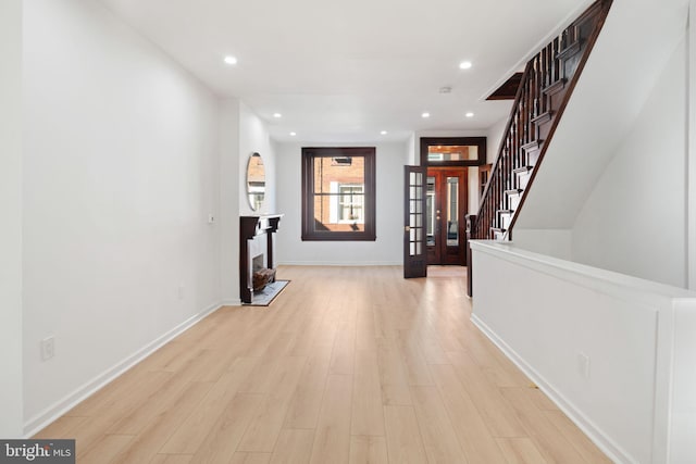 hall featuring french doors and light hardwood / wood-style flooring