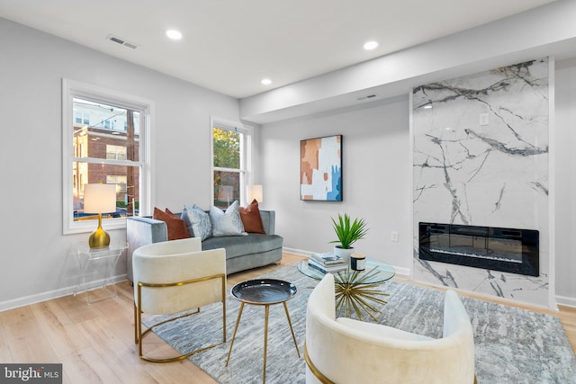 living room featuring a fireplace and light hardwood / wood-style floors