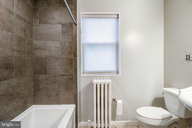 bathroom featuring radiator heating unit, tiled shower / bath combo, and toilet