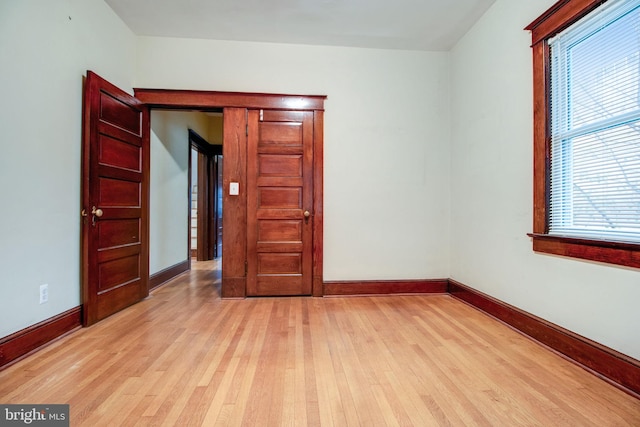 unfurnished room with light wood-type flooring