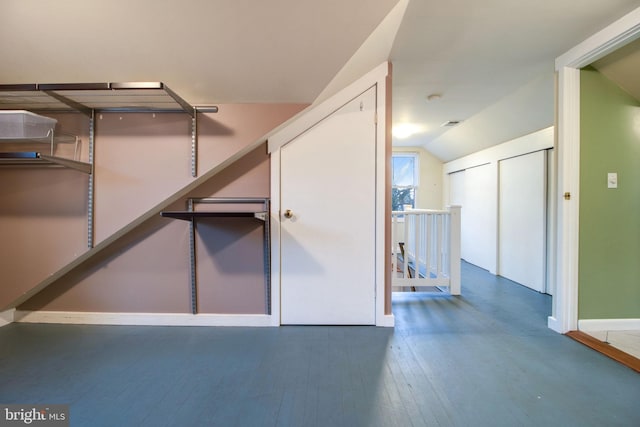 interior space featuring dark hardwood / wood-style floors and lofted ceiling