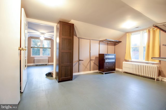 bonus room with ceiling fan, radiator heating unit, lofted ceiling, and hardwood / wood-style flooring