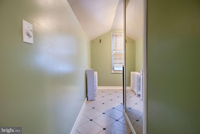 bathroom featuring tile patterned floors, radiator heating unit, and vaulted ceiling