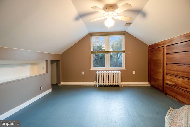 bonus room with radiator heating unit, dark hardwood / wood-style floors, ceiling fan, and lofted ceiling