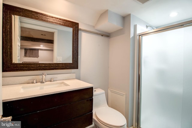 bathroom with vanity, toilet, and walk in shower