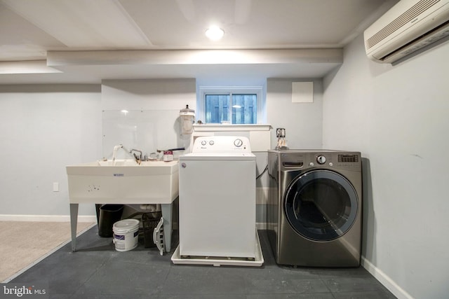 clothes washing area with an AC wall unit and washing machine and dryer