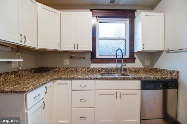 kitchen featuring white cabinets, dishwasher, dark stone countertops, and sink