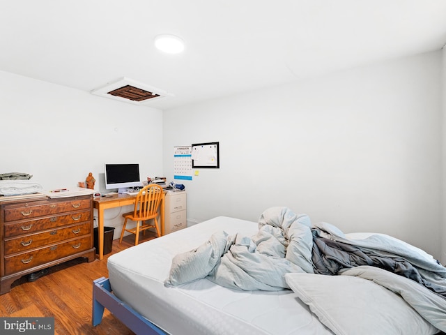 bedroom with hardwood / wood-style floors