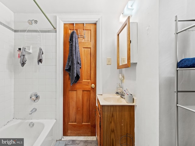 bathroom with tile patterned flooring, vanity, and tiled shower / bath combo