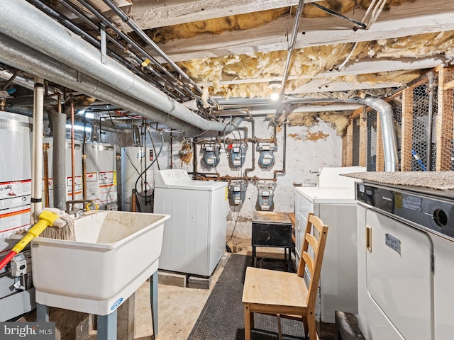 basement featuring washer and dryer, gas water heater, and sink