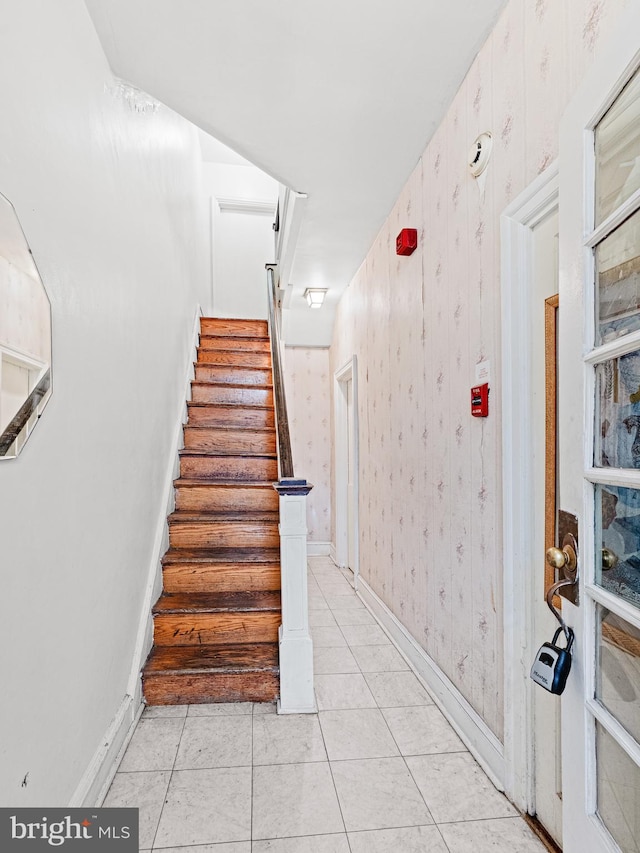 staircase featuring tile patterned flooring