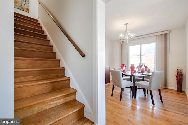 dining space featuring an inviting chandelier and light hardwood / wood-style flooring