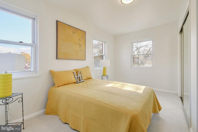 bedroom featuring light colored carpet