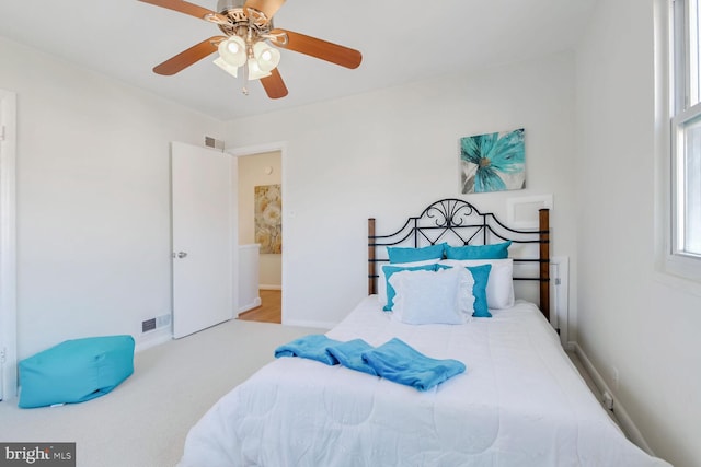 bedroom with light colored carpet and ceiling fan