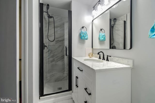 bathroom featuring vanity, tile patterned floors, and walk in shower