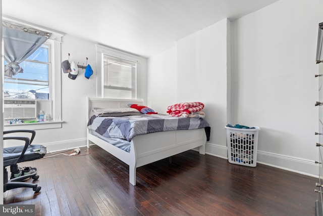 bedroom featuring cooling unit and dark wood-type flooring