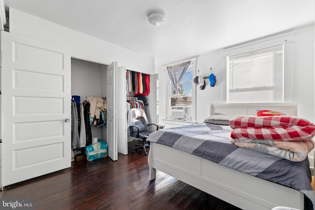 bedroom featuring cooling unit and dark wood-type flooring