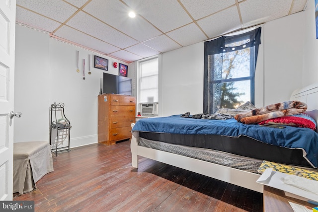 bedroom featuring hardwood / wood-style floors and a paneled ceiling