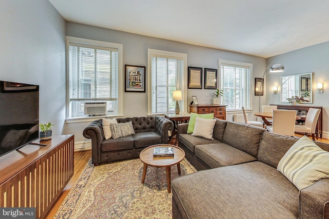 living room with light wood-type flooring and cooling unit