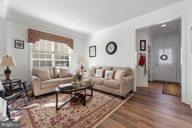 living room with dark hardwood / wood-style flooring and crown molding