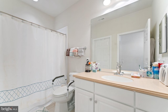 bathroom featuring toilet and vanity