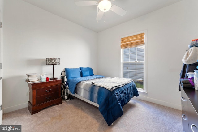 bedroom featuring ceiling fan and light carpet