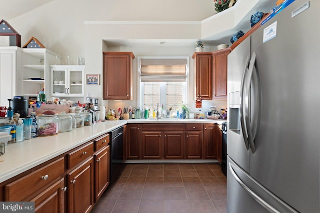 kitchen featuring stainless steel fridge, stove, dishwasher, dark tile patterned flooring, and sink