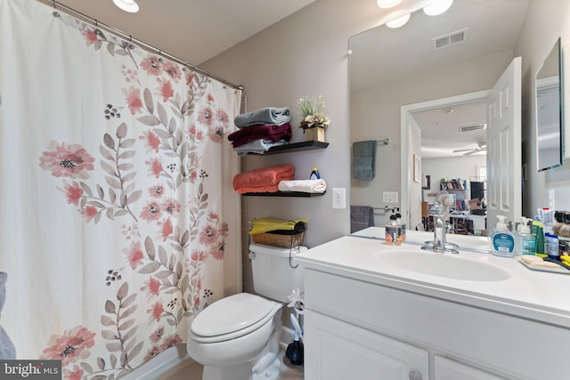 bathroom featuring toilet, walk in shower, and vanity