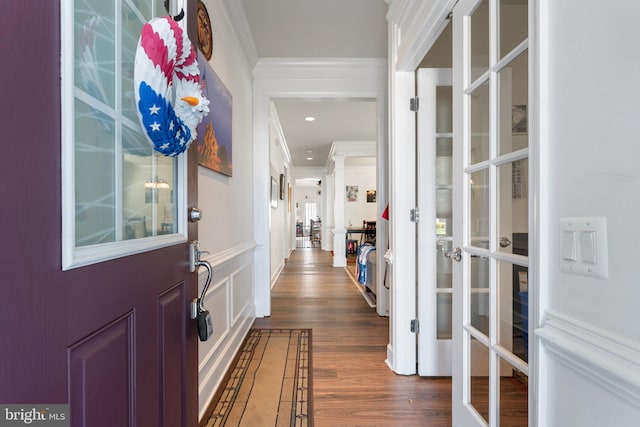 interior space featuring french doors, dark wood-type flooring, and crown molding