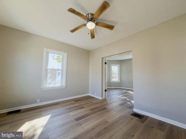 unfurnished room featuring light hardwood / wood-style floors, plenty of natural light, and ceiling fan