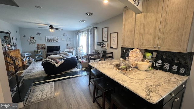 14 Buttonwood Rd, Stratford, NJ 08084 - kitchen with wood finished floors, decorative backsplash, a ceiling fan, a kitchen bar, and open floor plan