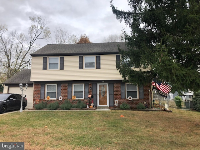 colonial inspired home featuring a garage, brick siding, and a front lawn