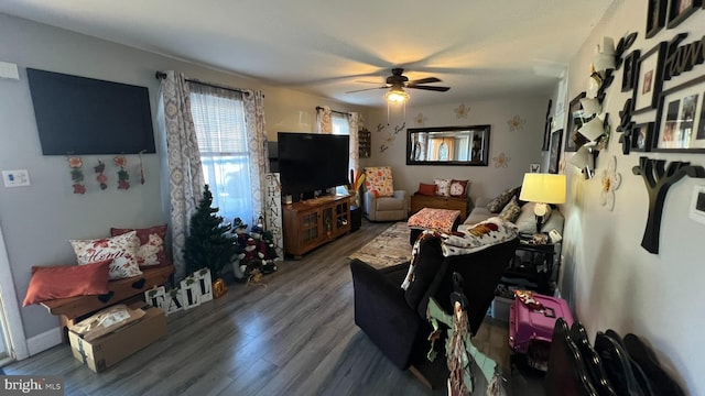 living area featuring a ceiling fan and wood finished floors