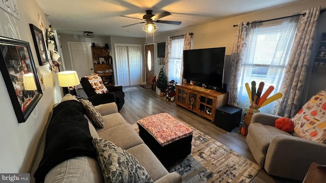 living area with wood finished floors and a ceiling fan